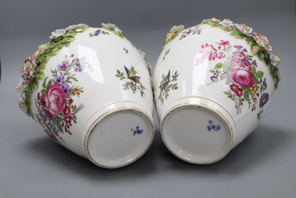 A pair of Augustus Rex floral encrusted porcelain vases and covers and a similar putti centrepiece, tallest 37cm